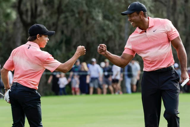 Tiger Woods and his son Charlie slipped off the pace (Kevin Kolczynski/AP)
